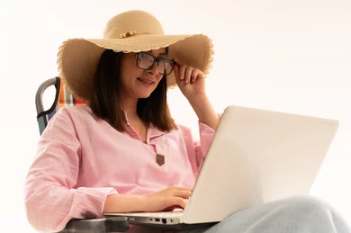 Arab Woman Using Laptop Wearing Straw Sun Hat