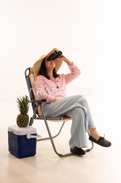 Woman on Beach Chair with Binoculars in Studio