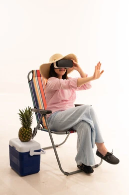 Saudi Woman Using VR Headset on Beach Chair