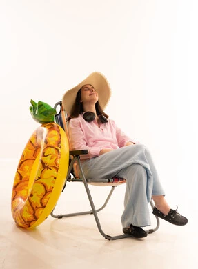 Woman on Beach Chair with Pineapple Swim Ring