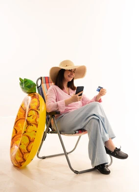 Woman Booking Summer Vacation with Credit Card