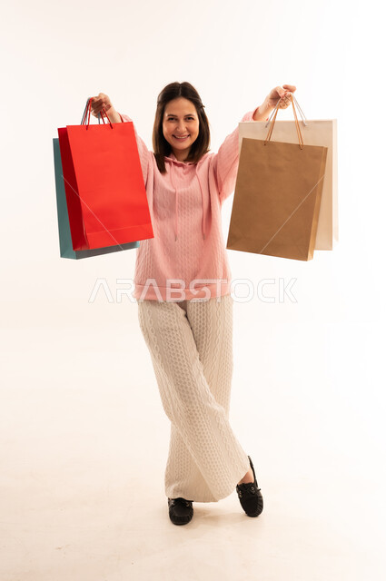 Woman Holding Shopping Bags in White Studio