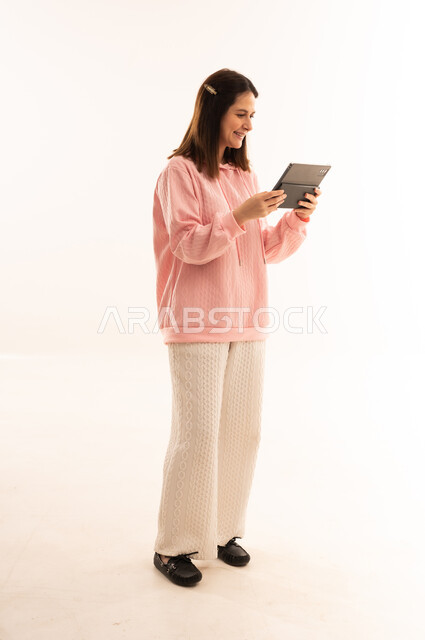 Smiling Arab Woman Using Digital Tablet in White Studio