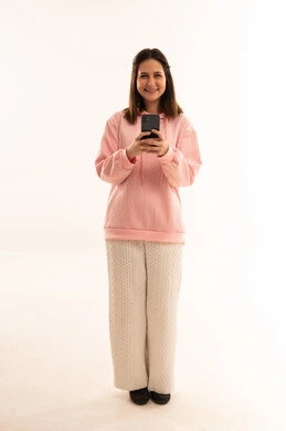 Woman Holding Smartphone in Pink Hoodie Studio