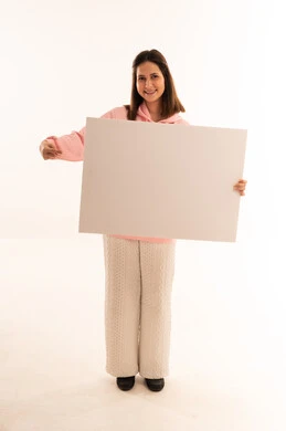 امرأة تمسك لوحة بيضاء فارغة على خلفية بيضاء