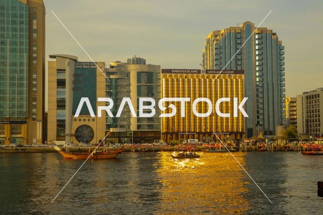 أفق خور دبي مع القوارب التقليدية عند الغروب