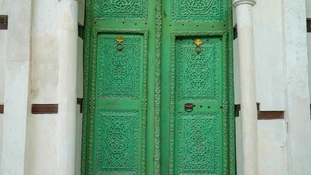 Ornate Green Wooden Door with Intricate Carvings