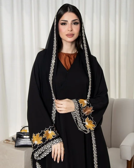 Saudi Woman in Black and Gold Embroidered Abaya