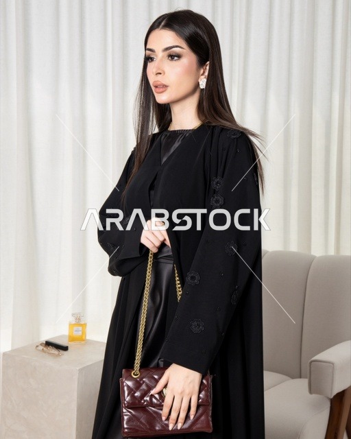 Saudi Woman in Black Abaya Holding Maroon Handbag
