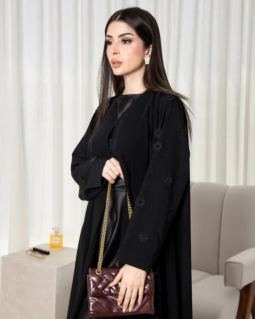 Saudi Woman in Black Abaya Holding Maroon Handbag