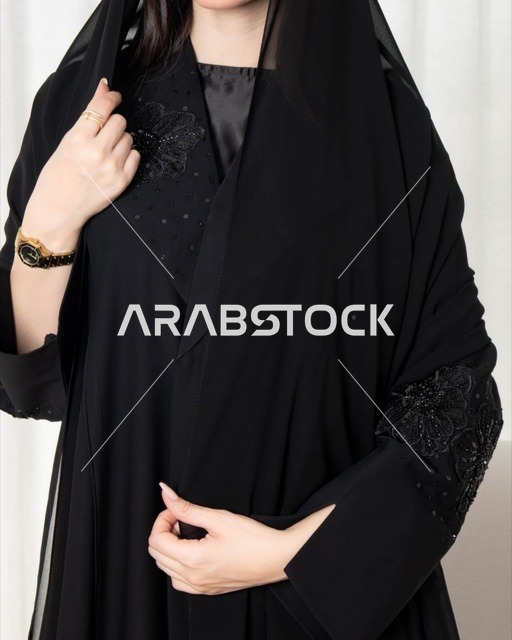 Saudi Woman in Black Embroidered Abaya and Gold Watch