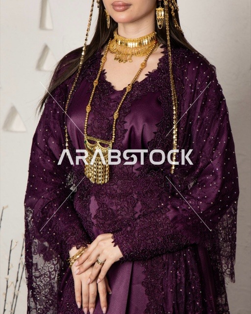 Saudi Woman in Traditional Purple Gown and Gold Jewelry