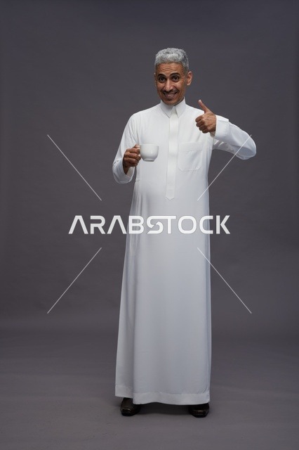 Arab Man in White Thobe With Coffee and Thumbs Up