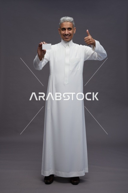 Saudi Man in Thobe Holding Blank Card Thumbs Up