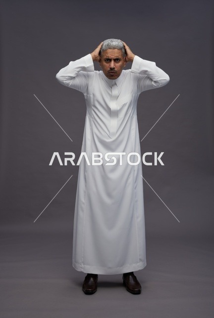 رجل سعودي محبط بالثوب الأبيض خلفية رمادية