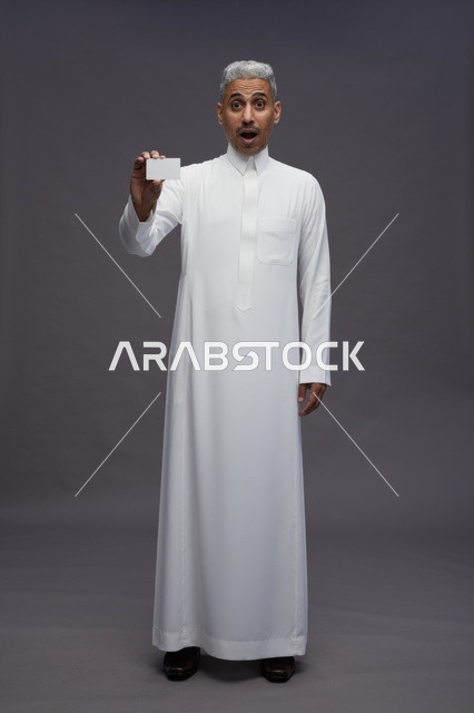 Surprised Arab Man in White Thobe Holding Blank Business Card