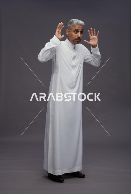 Saudi Man in Thobe Gesturing Surprise on Grey Background