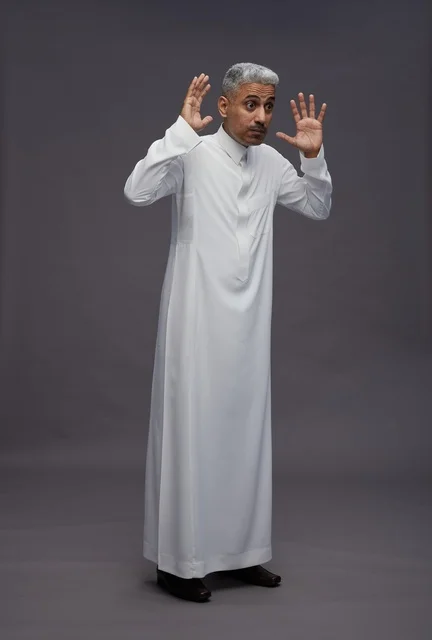 Saudi Man in Thobe Gesturing Surprise on Grey Background