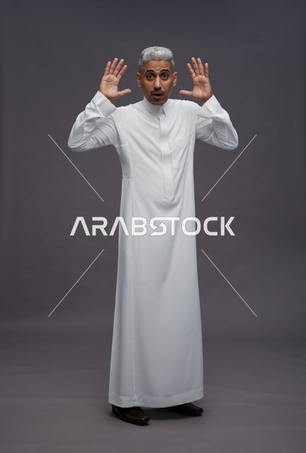 Surprised Saudi Man in White Thobe on Grey Background