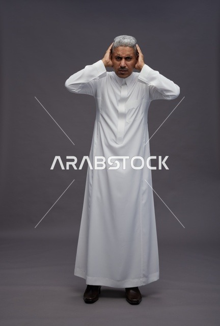 Saudi Man in Thobe Covering Ears on Grey Background