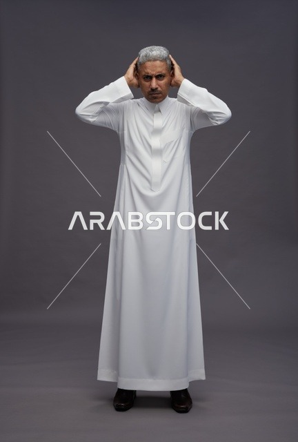 Saudi Man in White Thobe Raising Hands for Prayer