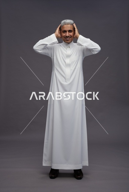 رجل سعودي بالثوب الأبيض التقليدي خلفية استوديو