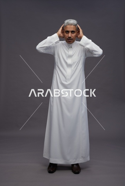 Saudi Man in White Thobe on Grey Background Studio