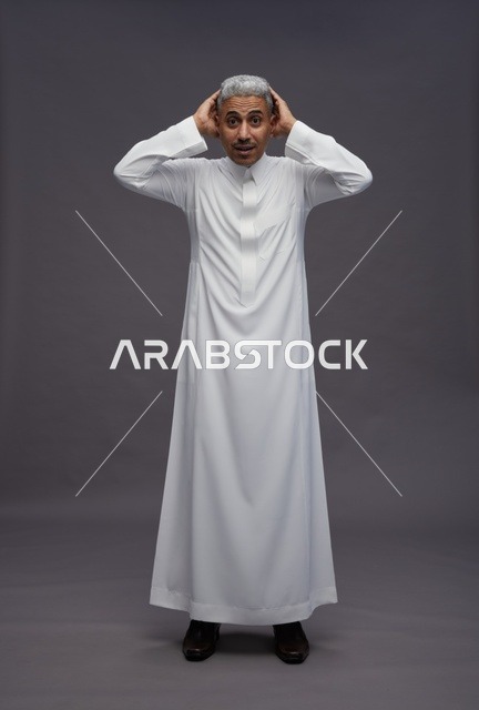 Shocked Saudi Man in White Thobe on Grey Background