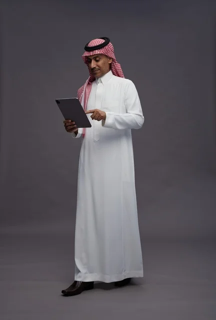 Saudi Man Using Digital Tablet in Studio Portrait