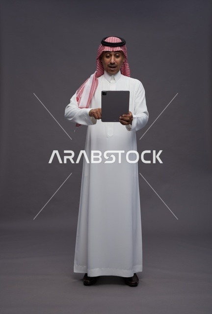 Saudi Man with Tablet Surprised Expression Studio Shot