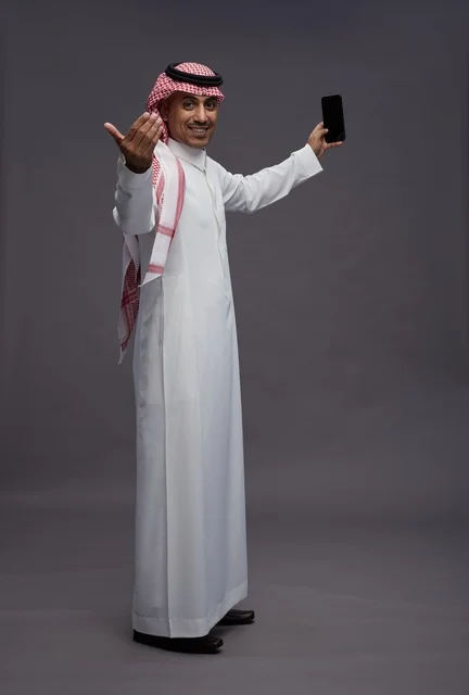 Saudi Man with Smartphone Making Welcoming Gesture