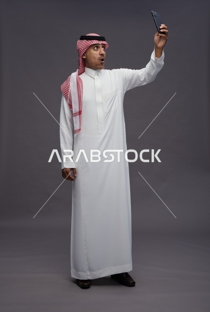 Shocked Saudi Man Using Smartphone in Studio
