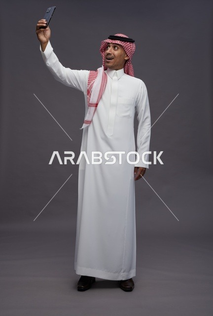 Saudi Man Taking Selfie with Smartphone in Studio