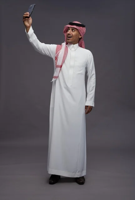Saudi Man Taking Selfie with Smartphone in Studio