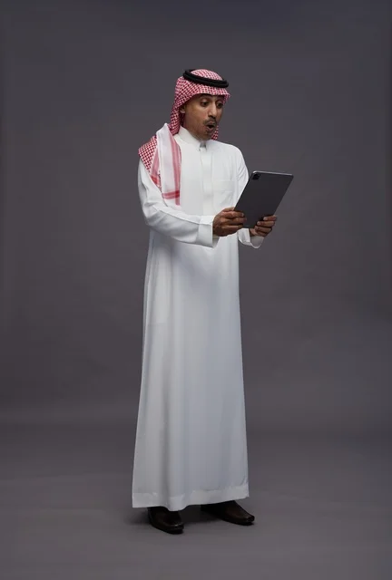 Saudi Man Surprised Looking at Tablet in Studio