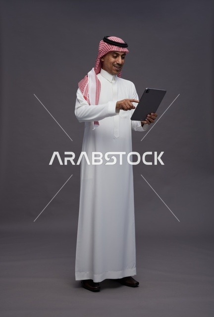 Saudi Man Using Digital Tablet in Studio Setting