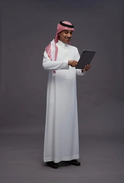 Saudi Man Using Digital Tablet in Studio Setting