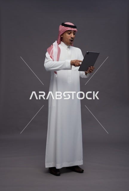 Surprised Saudi Man Using Digital Tablet in Studio