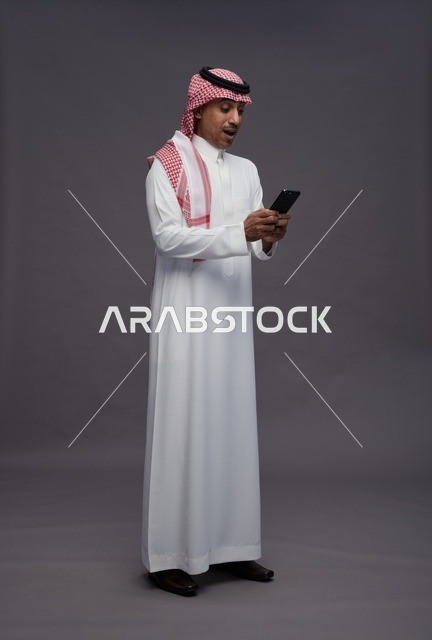 Surprised Saudi Man Using Smartphone in Studio