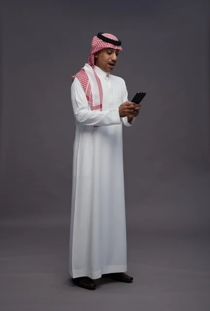 Surprised Saudi Man Using Smartphone in Studio