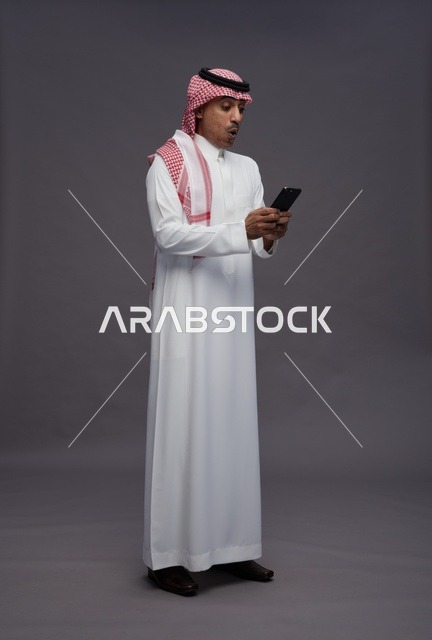 Saudi Man with Smartphone Surprised Expression Studio