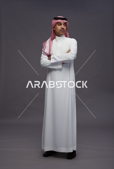Saudi Man in Traditional Thobe on Gray Background