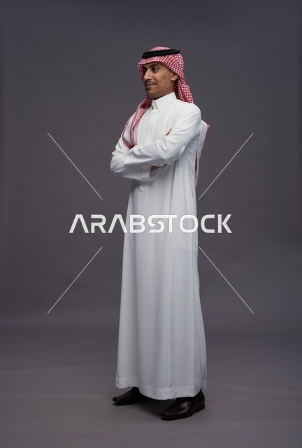 Saudi Man in Traditional Thobe on Grey Studio Background