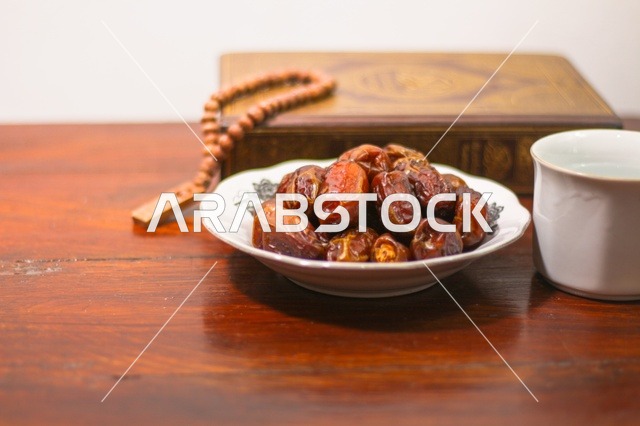 Ramadan Dates with Prayer Beads on Wooden Table