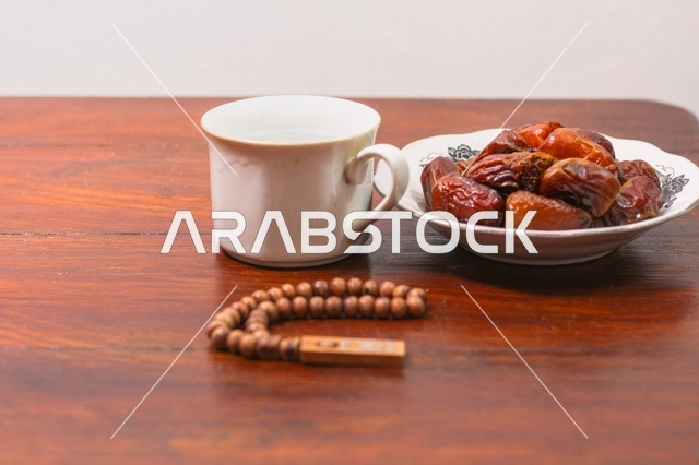 Ramadan Dates and Prayer Beads on Wooden Table