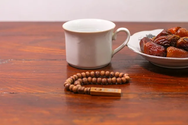 Ramadan Dates and Prayer Beads on Wooden Table