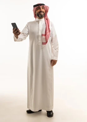 Saudi Man in Traditional Thobe Holding Smartphone