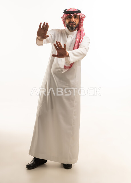 Saudi Man in Thobe Making Stop Gesture on White Background
