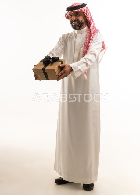 Saudi Man in Traditional Thobe Holding Gift Box