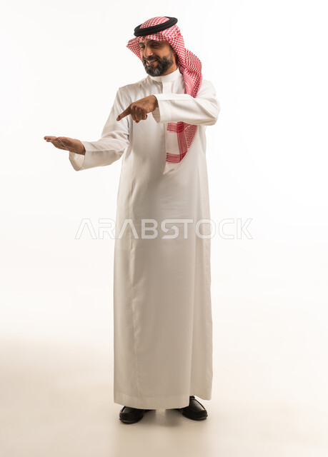Saudi Man in Traditional Thobe Pointing at Open Palm